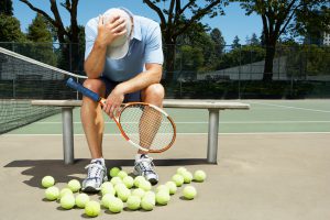 Tennis player with his head in his hands
