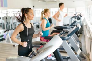 People running on treadmill at gym